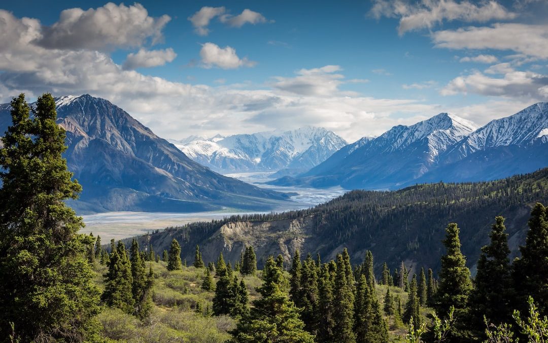 green mountain across body of water