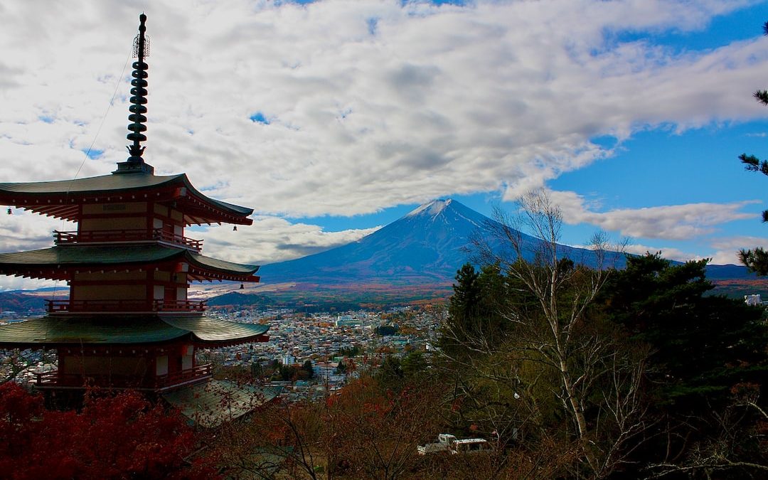 a tall tower with a mountain in the background