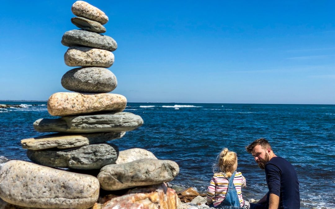 man and girl on beach