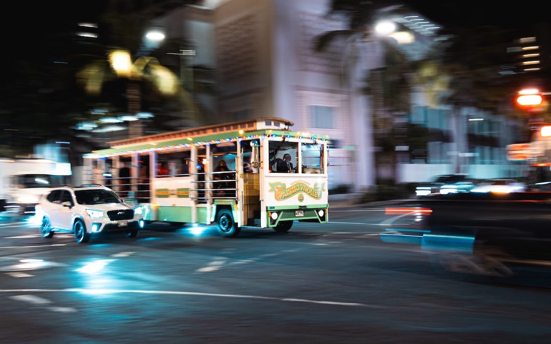 a bus driving down a city street at night