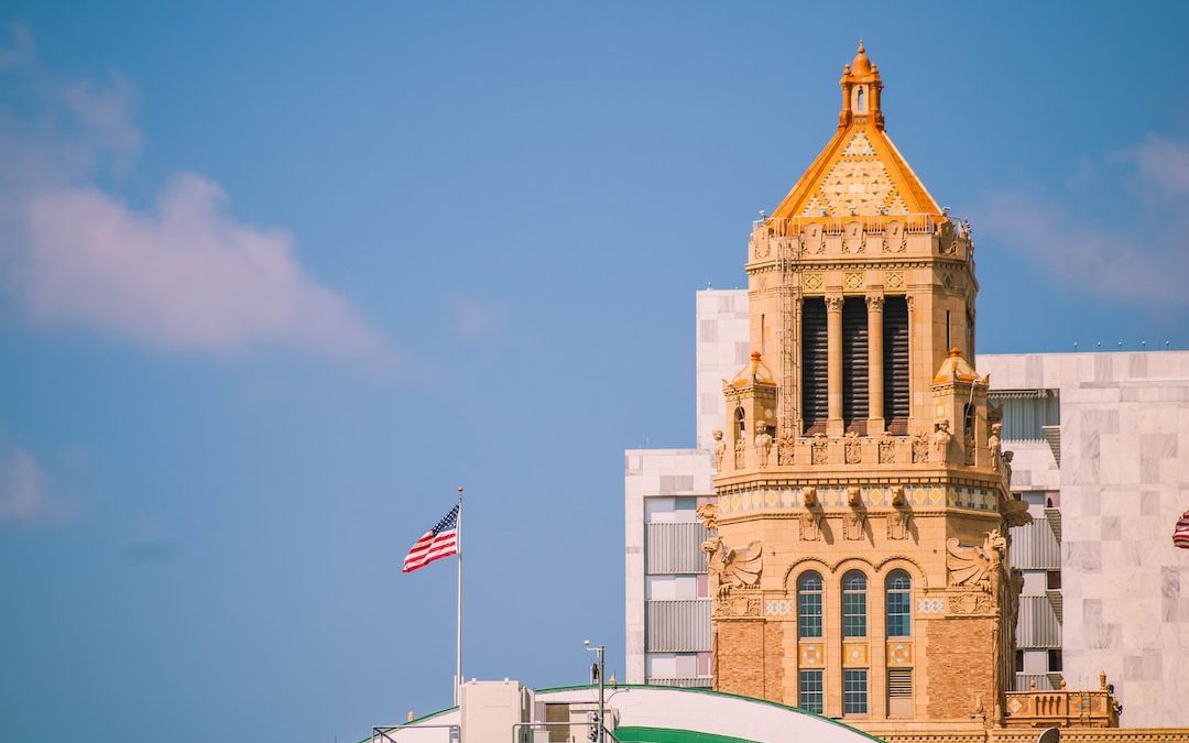 brown concrete building with flag of us a during daytime