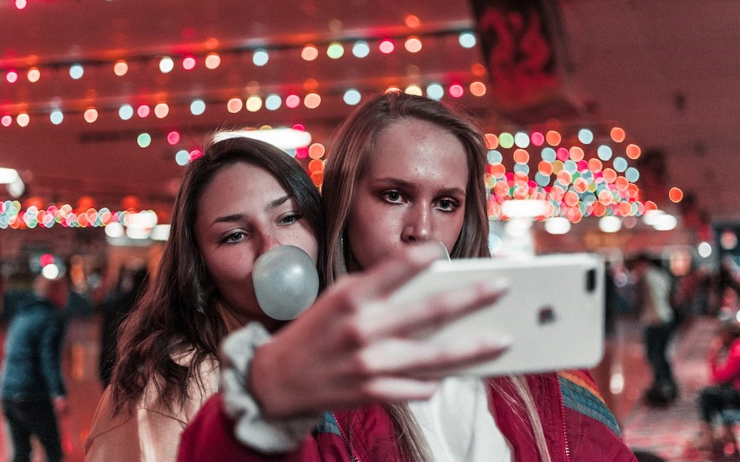 women takes photo inside building near people