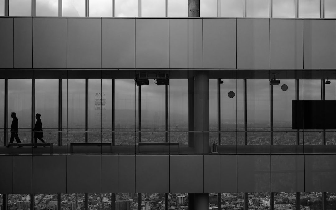 grayscale photography of two men inside building