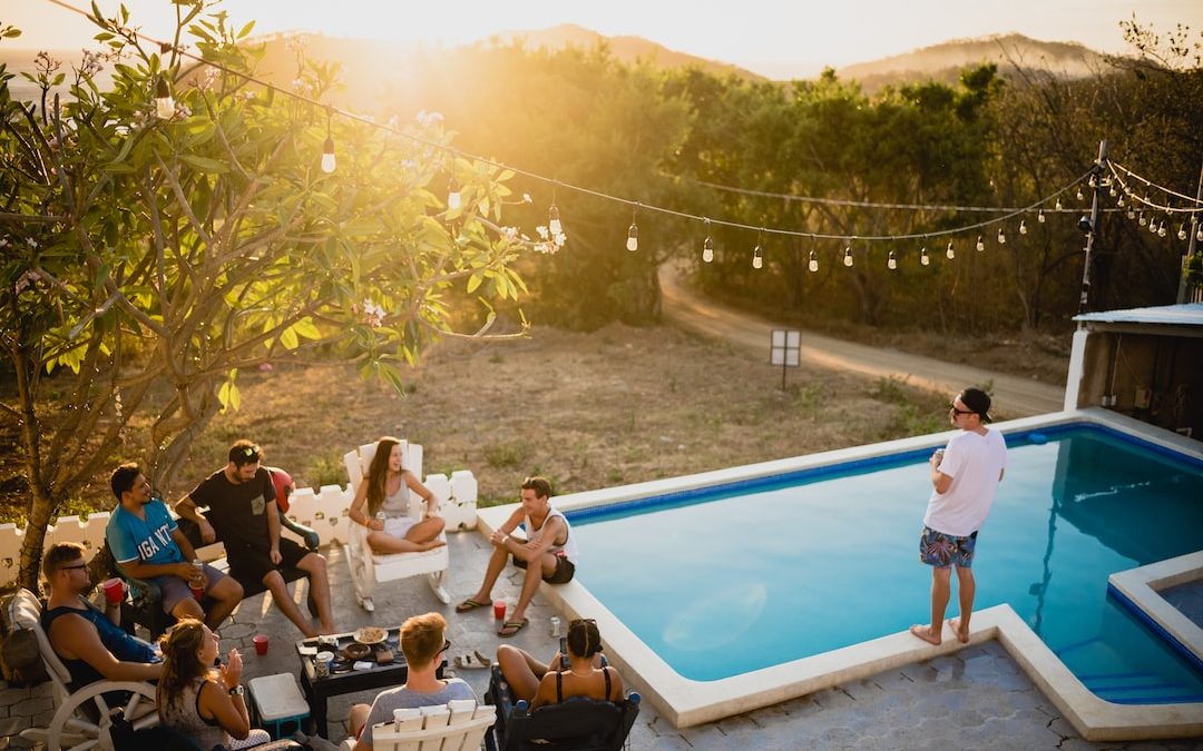 people sitting on chairs near pool