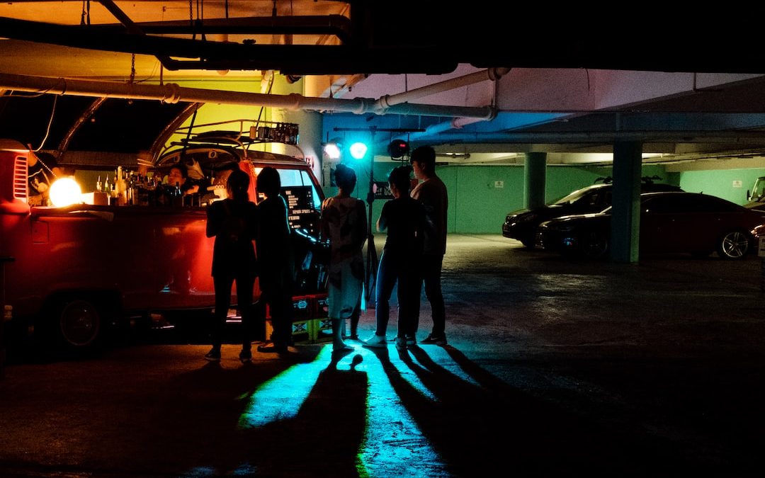 five person standing near vehicle at garage