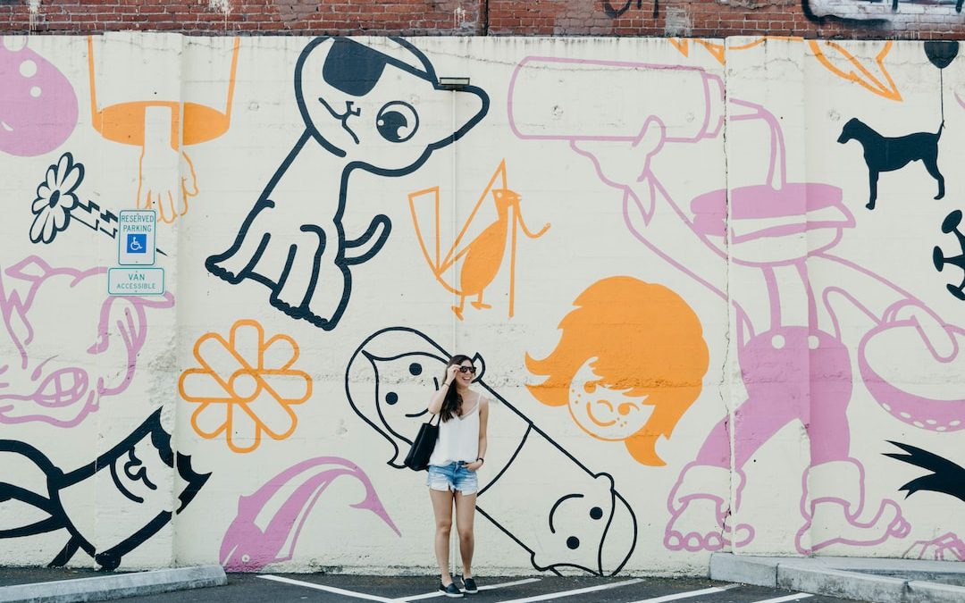 candid photography of woman standing against graffiti wall with broad smile