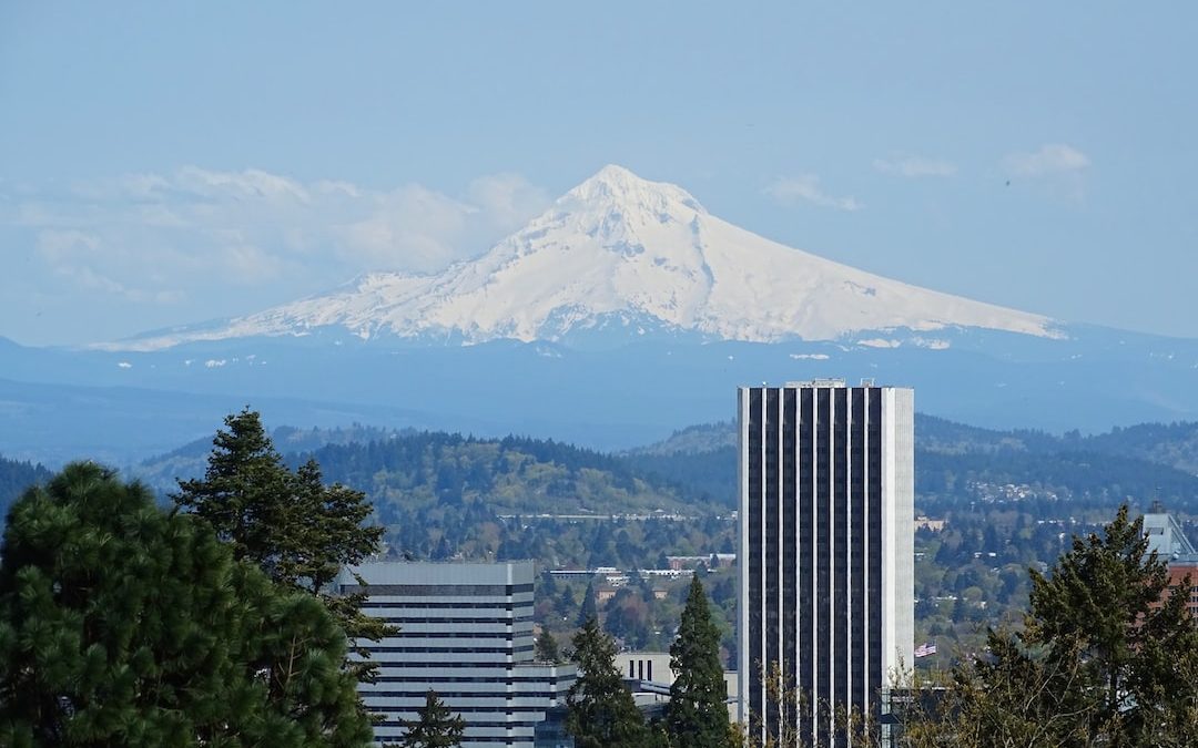 a tall building with a mountain in the background