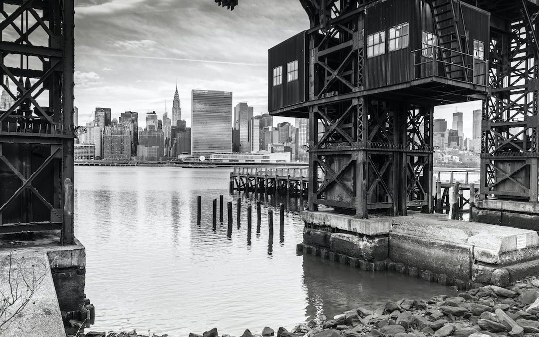 body of water near city buildings during daytime