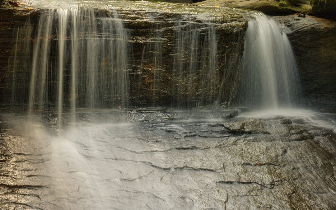 water falls on gray rock
