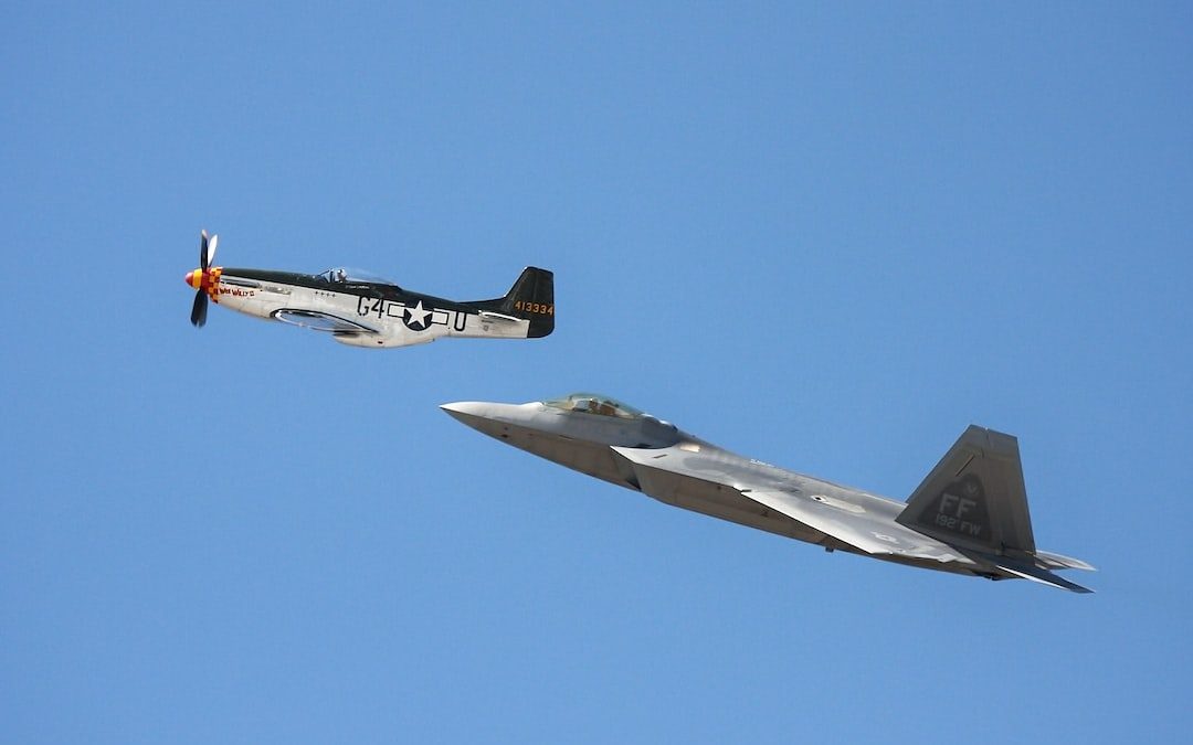 white-and-black monoplane and gray jet