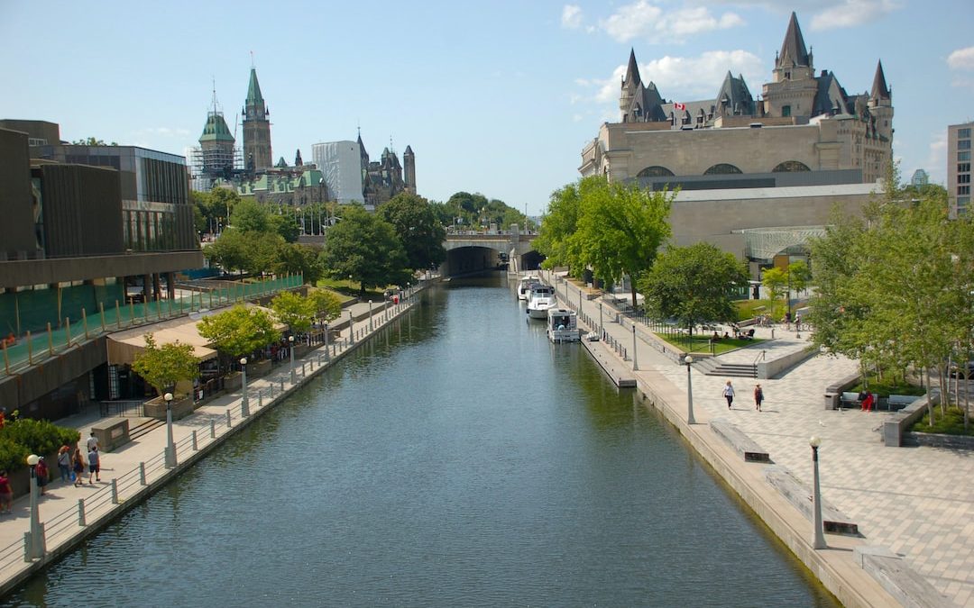 a river running through a city next to tall buildings