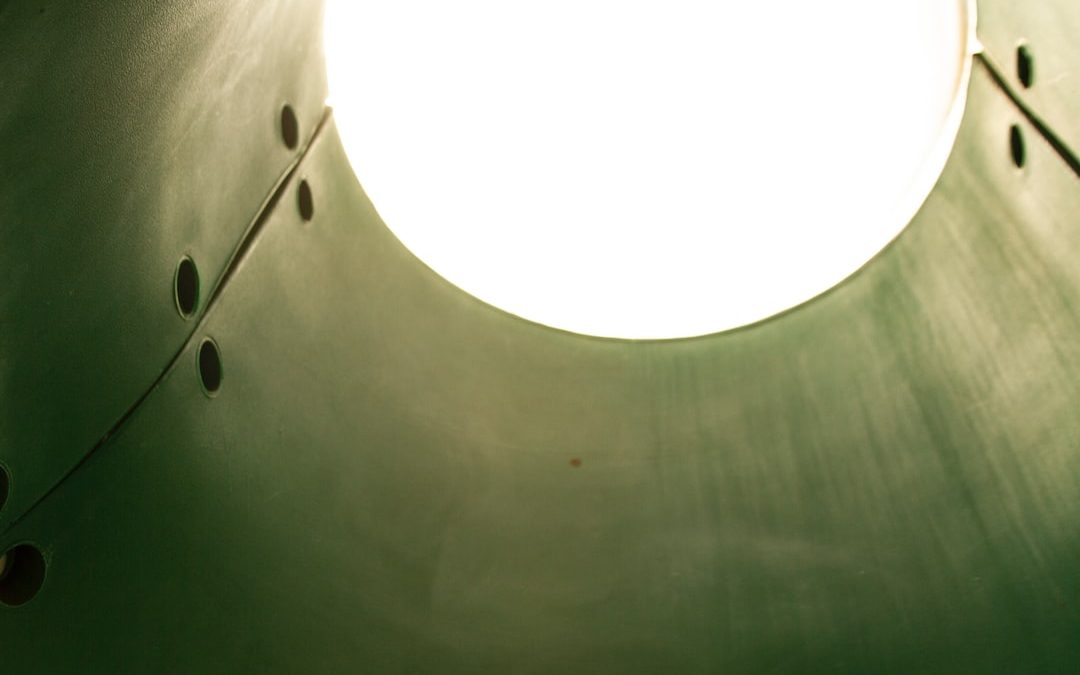a round light hanging from a ceiling in a room