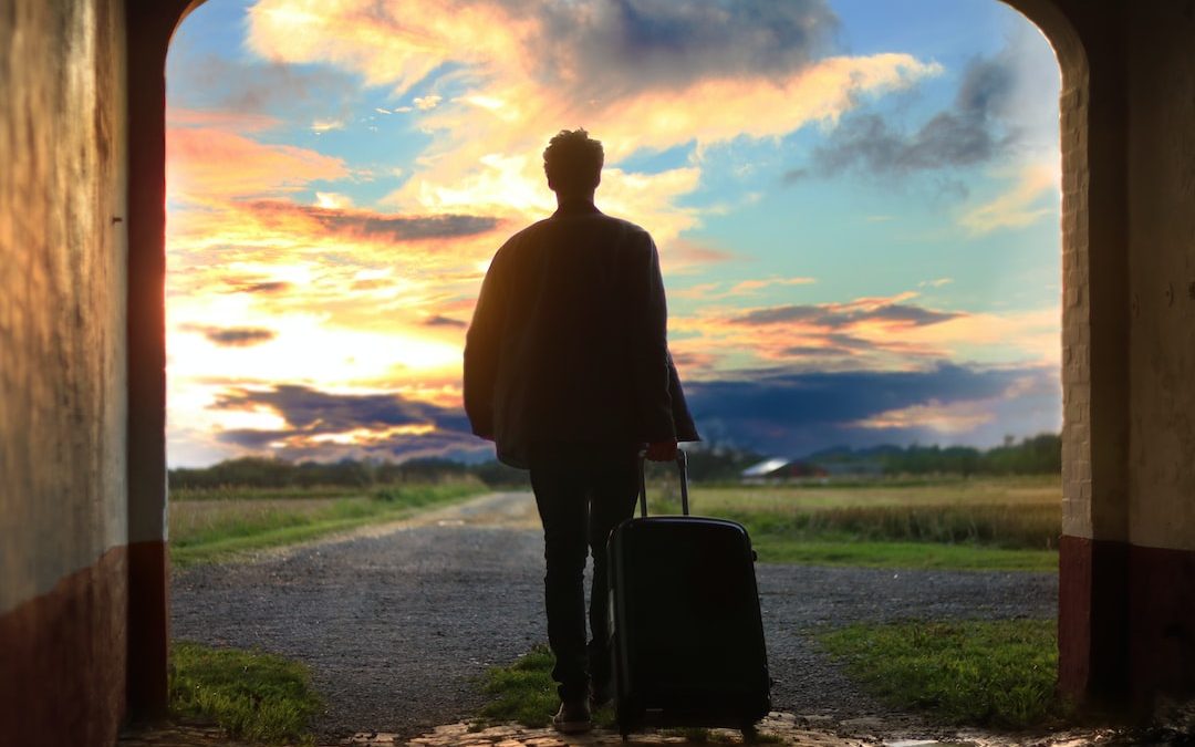 man holding luggage photo