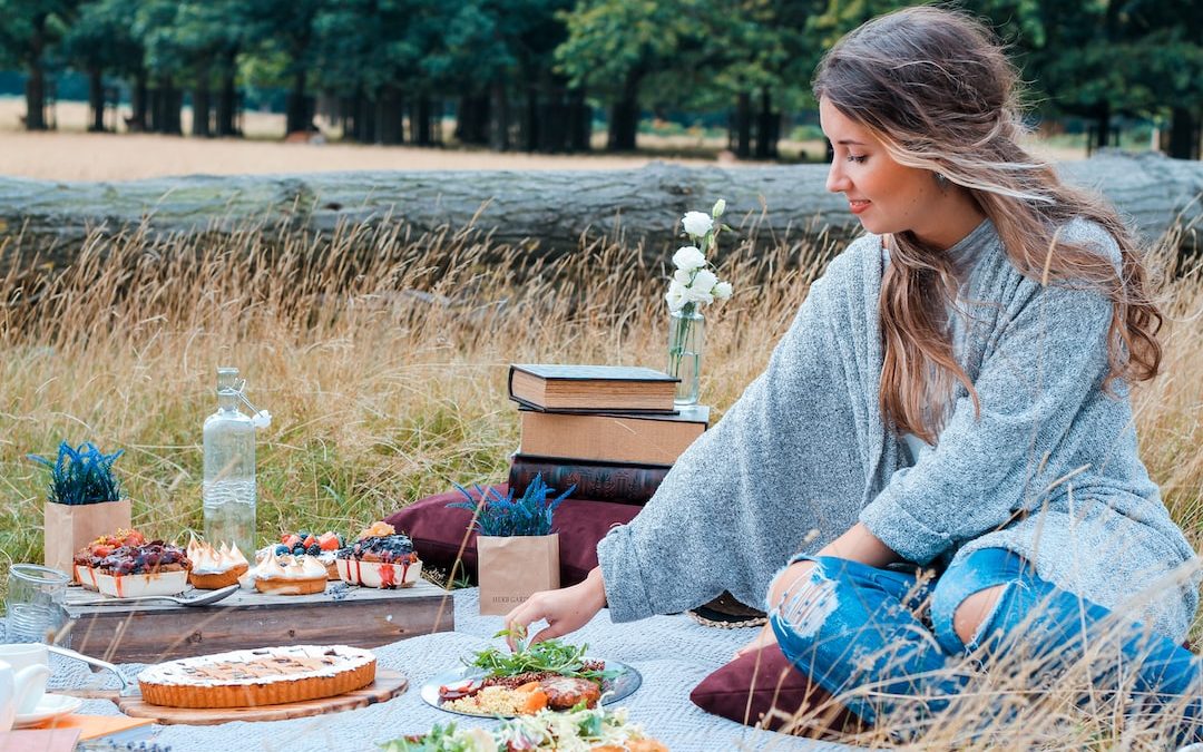 woman sitting on picnic mat