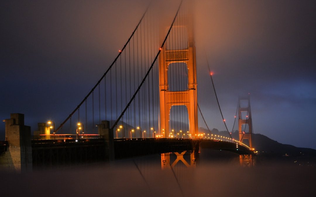 brown bridge with lights during nighttime