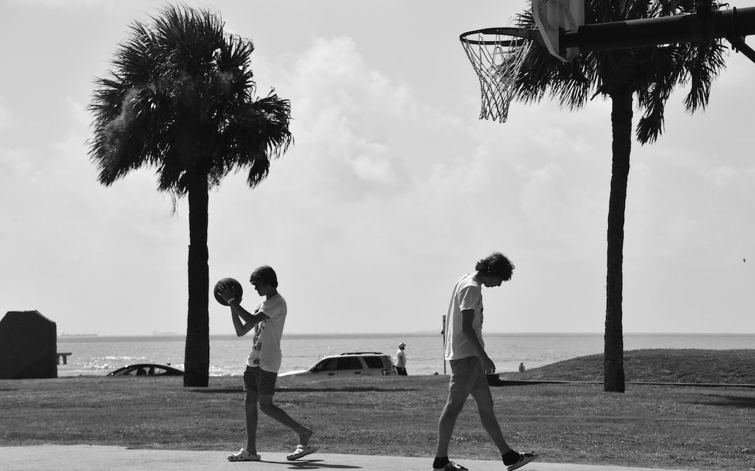 a couple of people play basketball