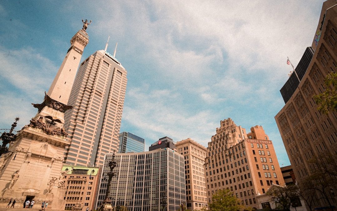 a group of buildings with a statue on top