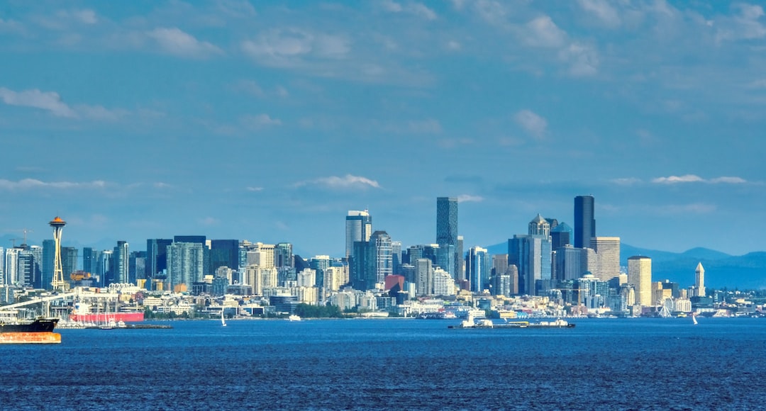 a city skyline with a body of water in the foreground