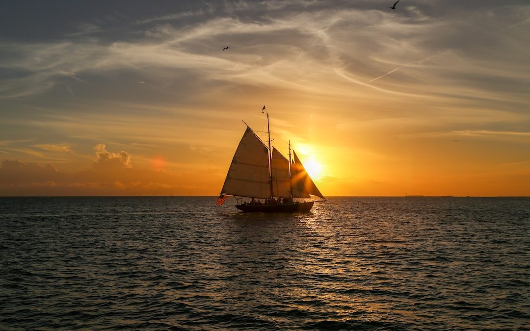 gray sailboat sailing