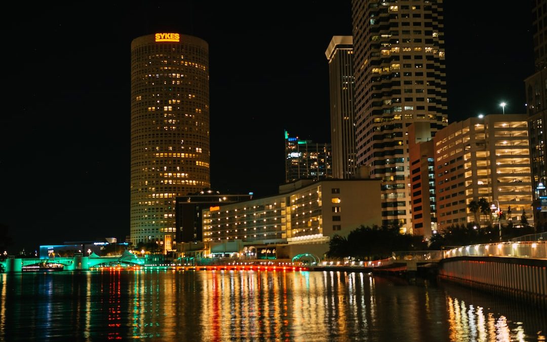 a city at night with lights reflecting in the water