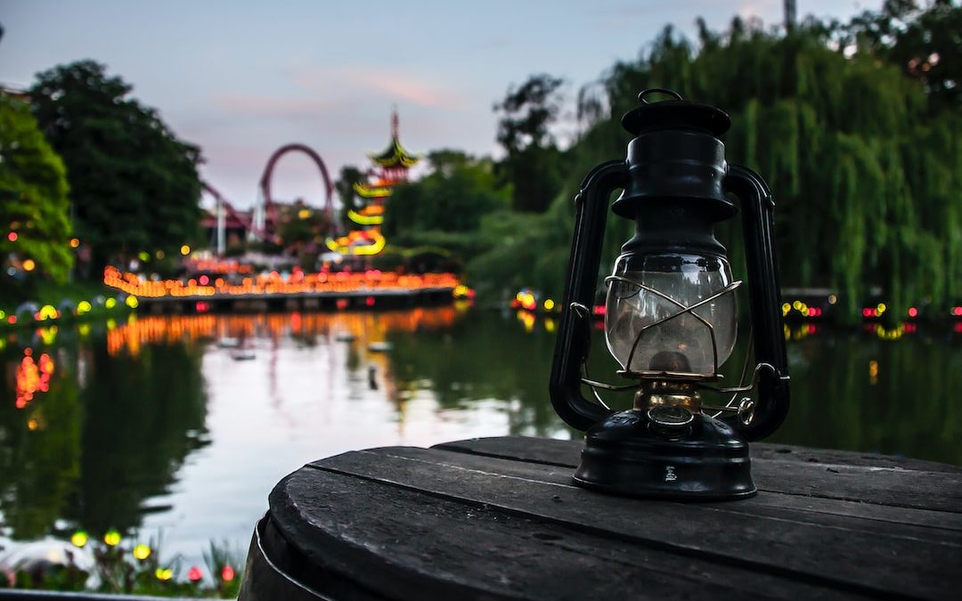 a lantern sitting on top of a wooden table