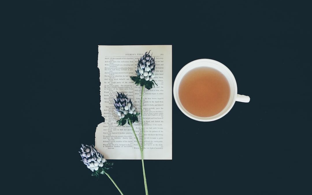 white ceramic tea cup beside white flowers