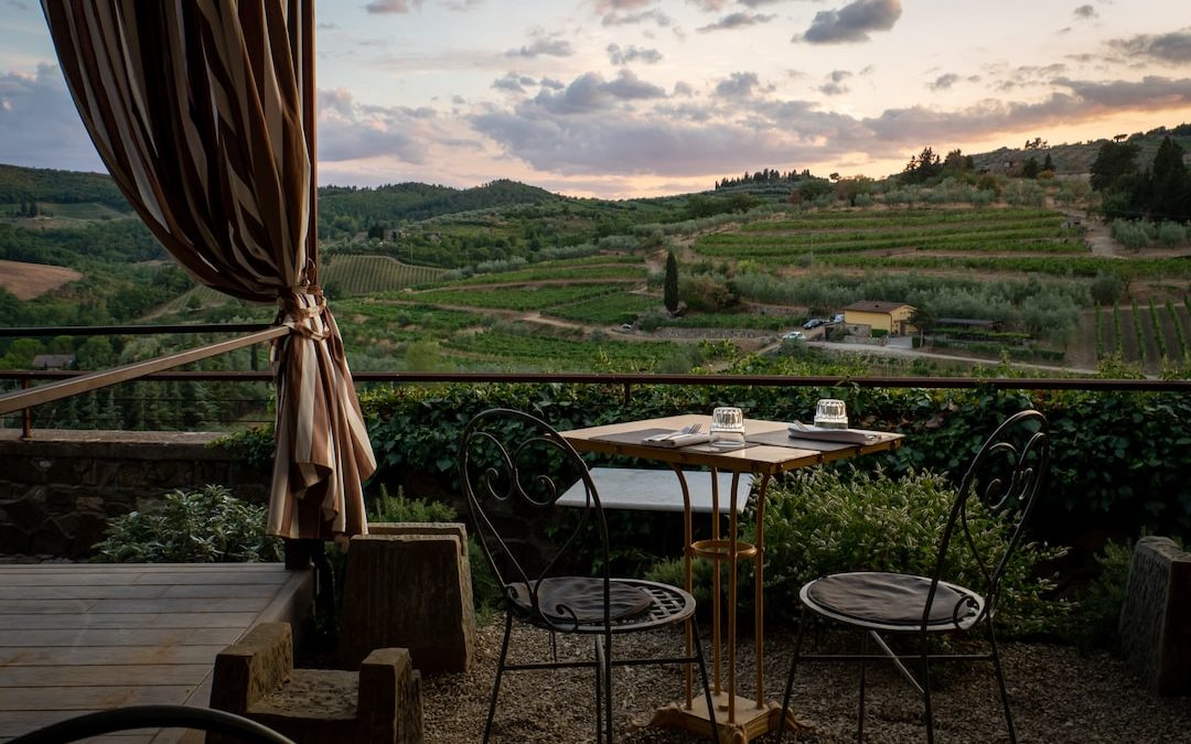 a table and chairs on a patio with a view