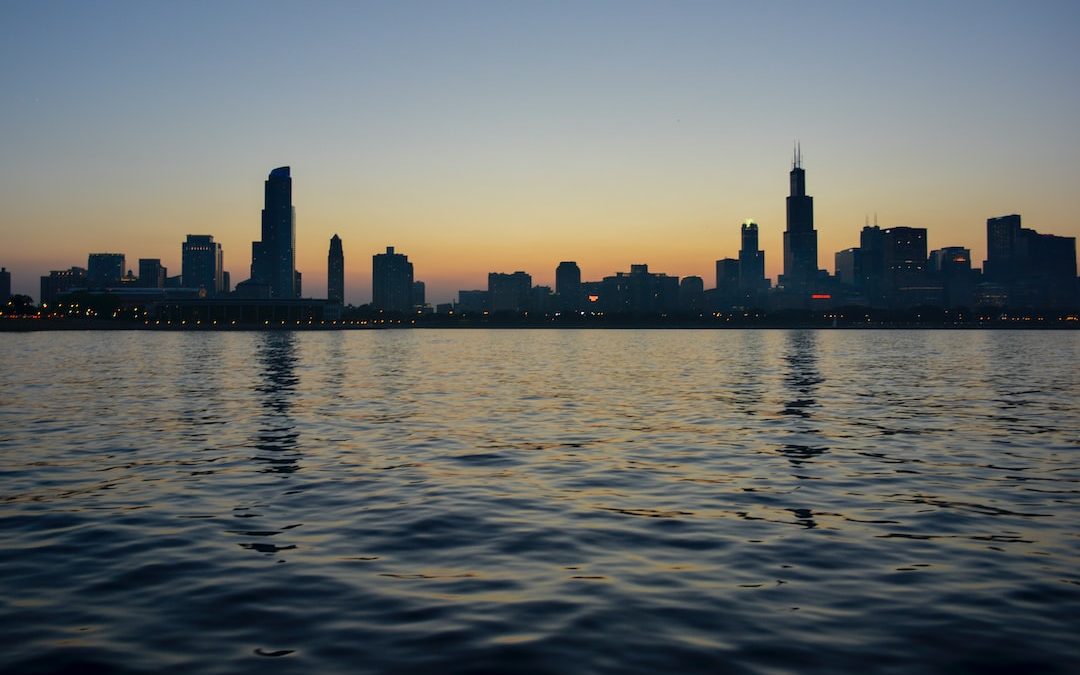 silhouette of city skyline near body of water