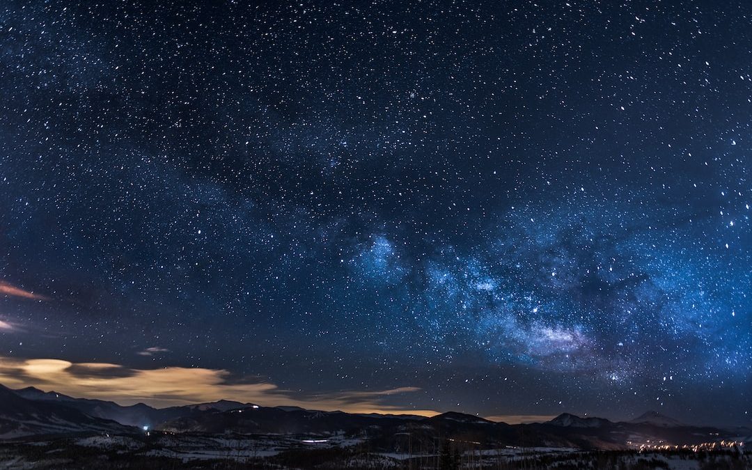 mountains with trees under white star at night