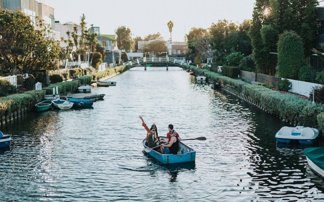 two person on blue boat during daytime