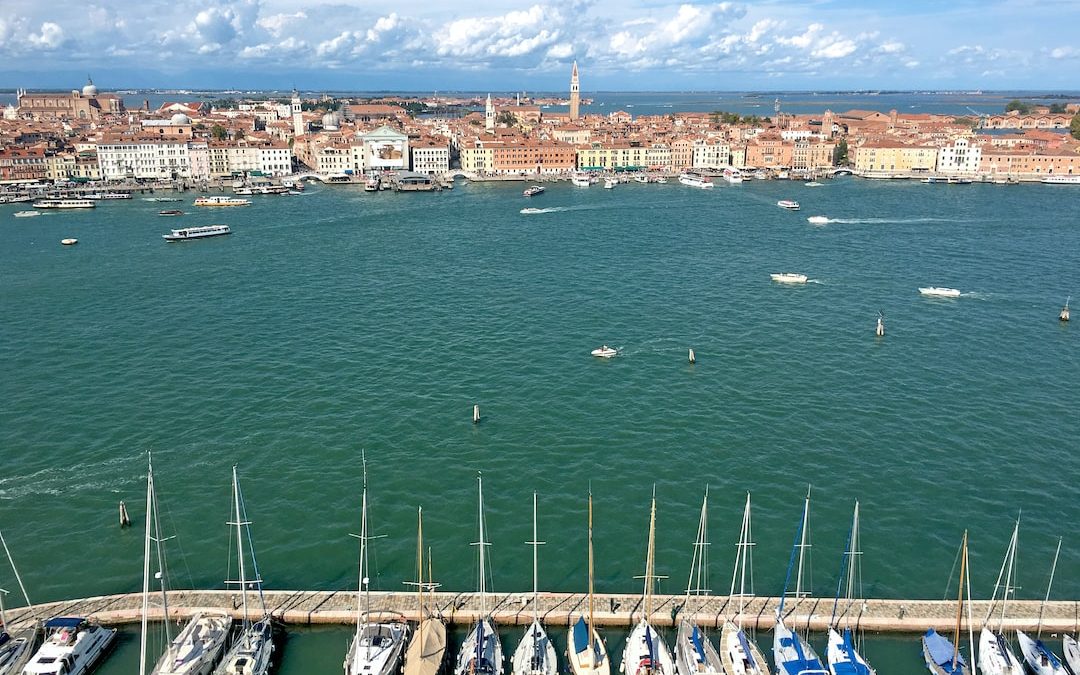 aerial view of white and green boat on sea dock during daytime