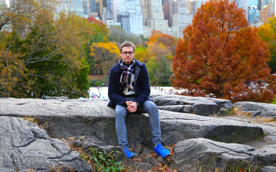 a man sitting on a rock