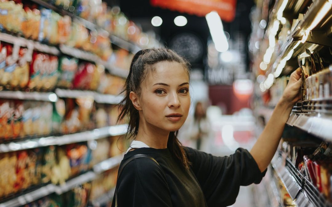 woman selecting packed food on gondola