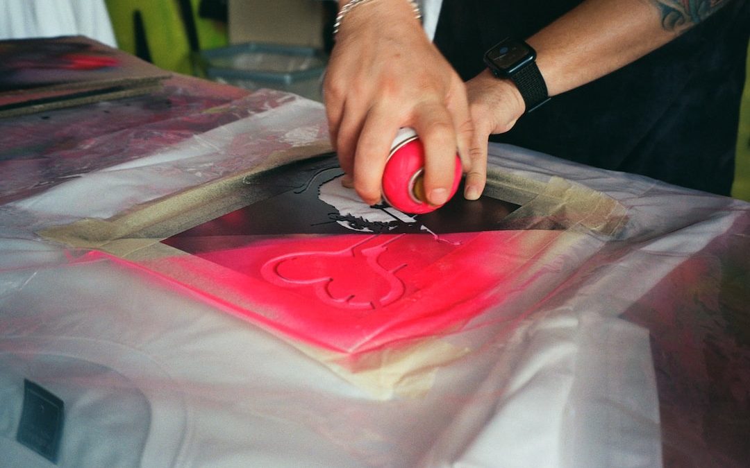 a man cutting a red piece of paper with scissors