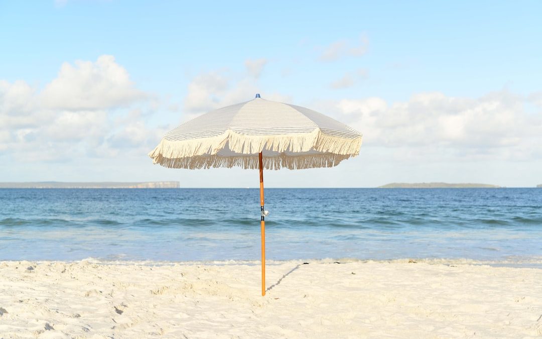white umbrella on seashore