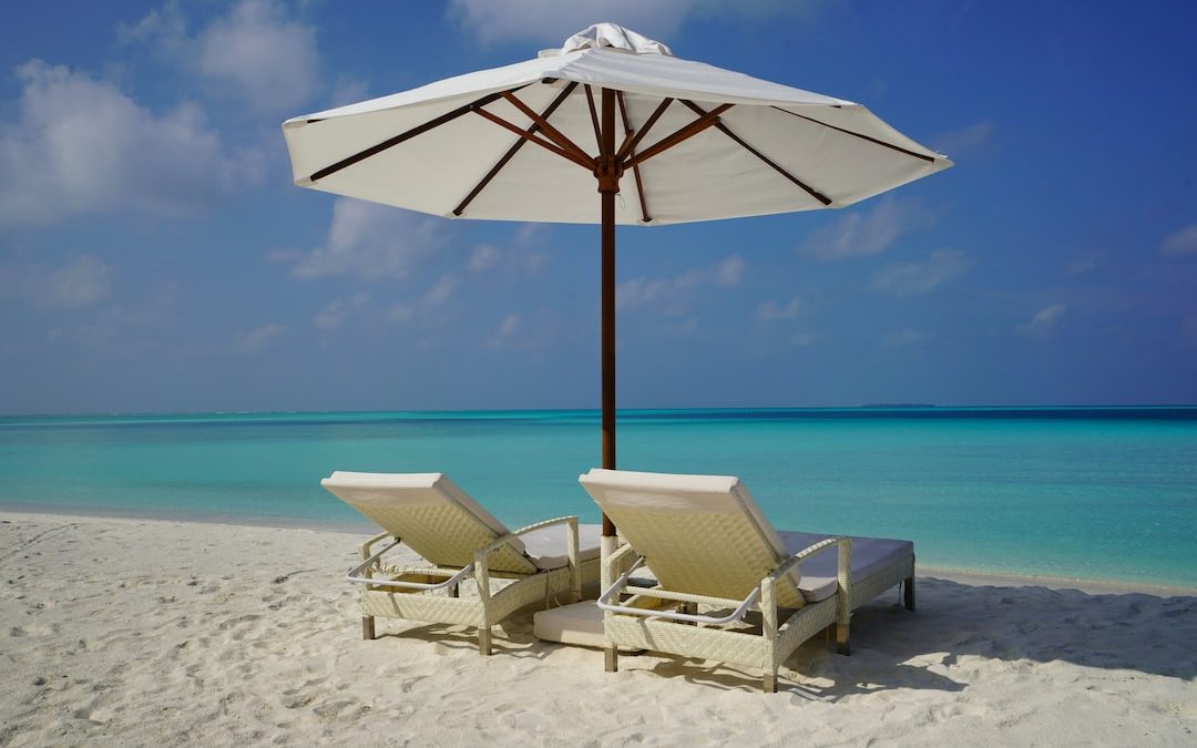 white and brown beach umbrella on white sand beach during daytime