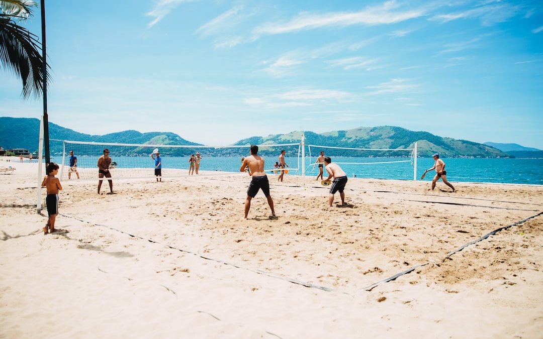 men playing volleyball on sand