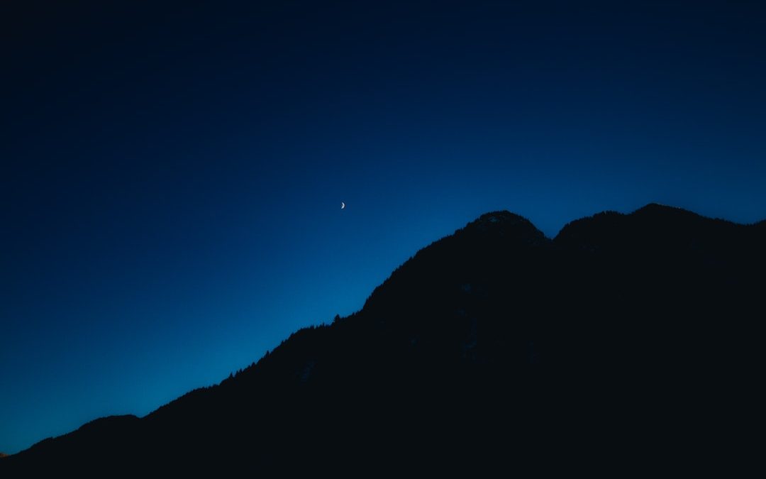 silhouette of mountain under blue sky