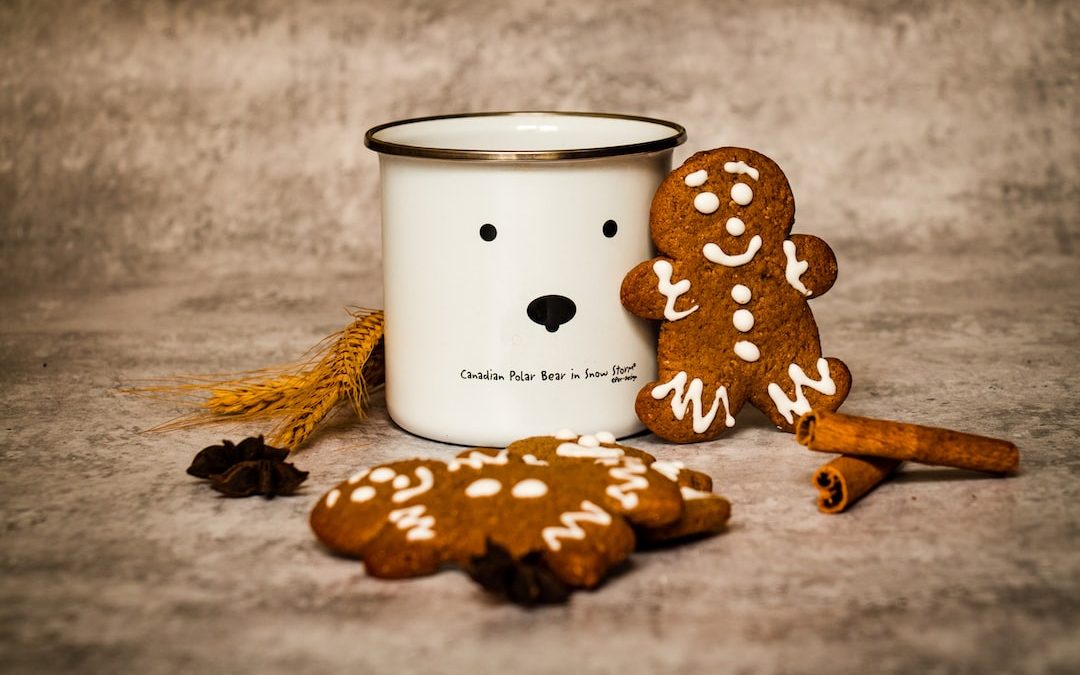 white and black polka dot ceramic mug on brown wooden table