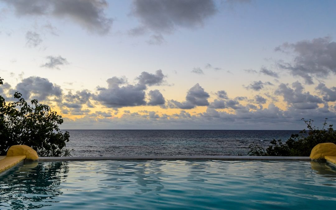 a large swimming pool with a view of the ocean