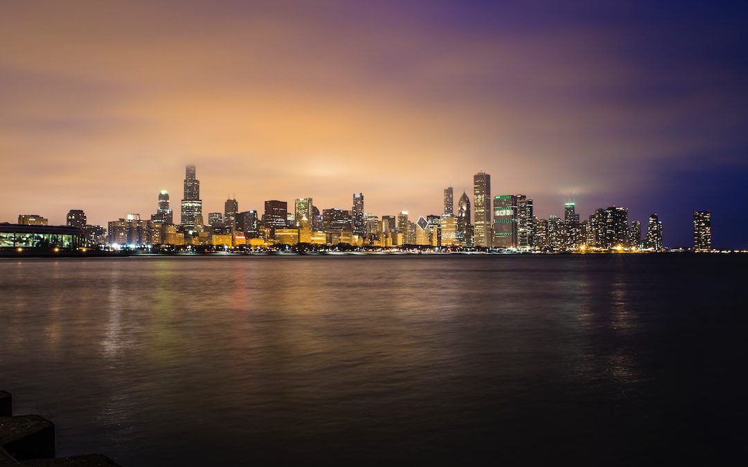 city skyline near body of water during golden hour