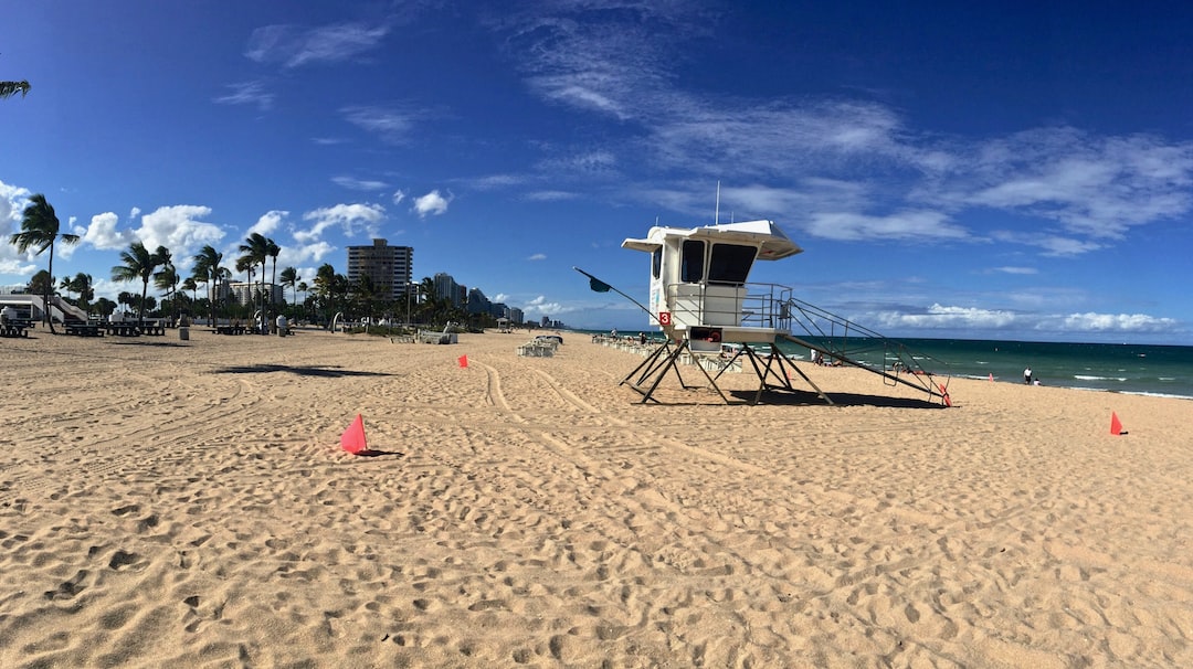 white and brown lifeguard house on beach during daytime