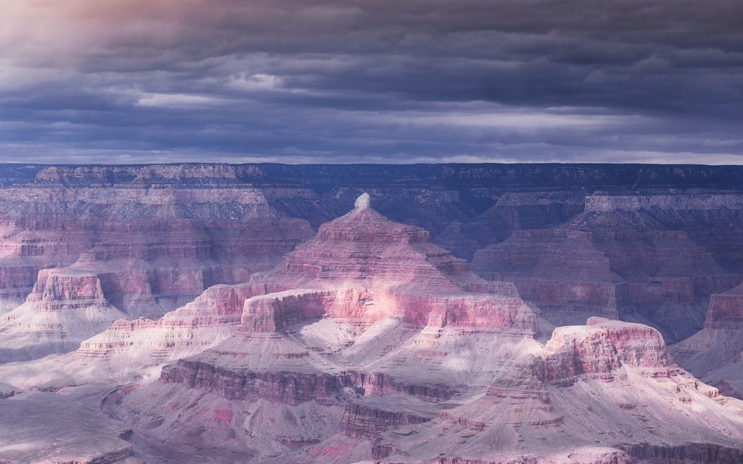 brown rock formation under gray clouds during daytime