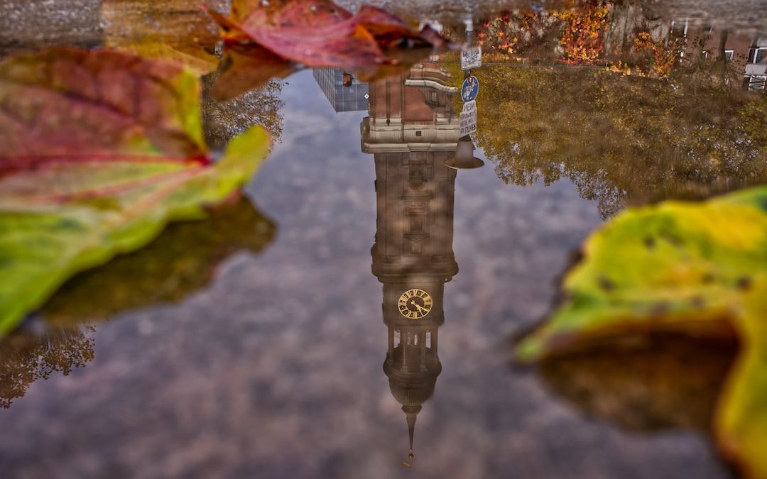 clock tower reflecting on water