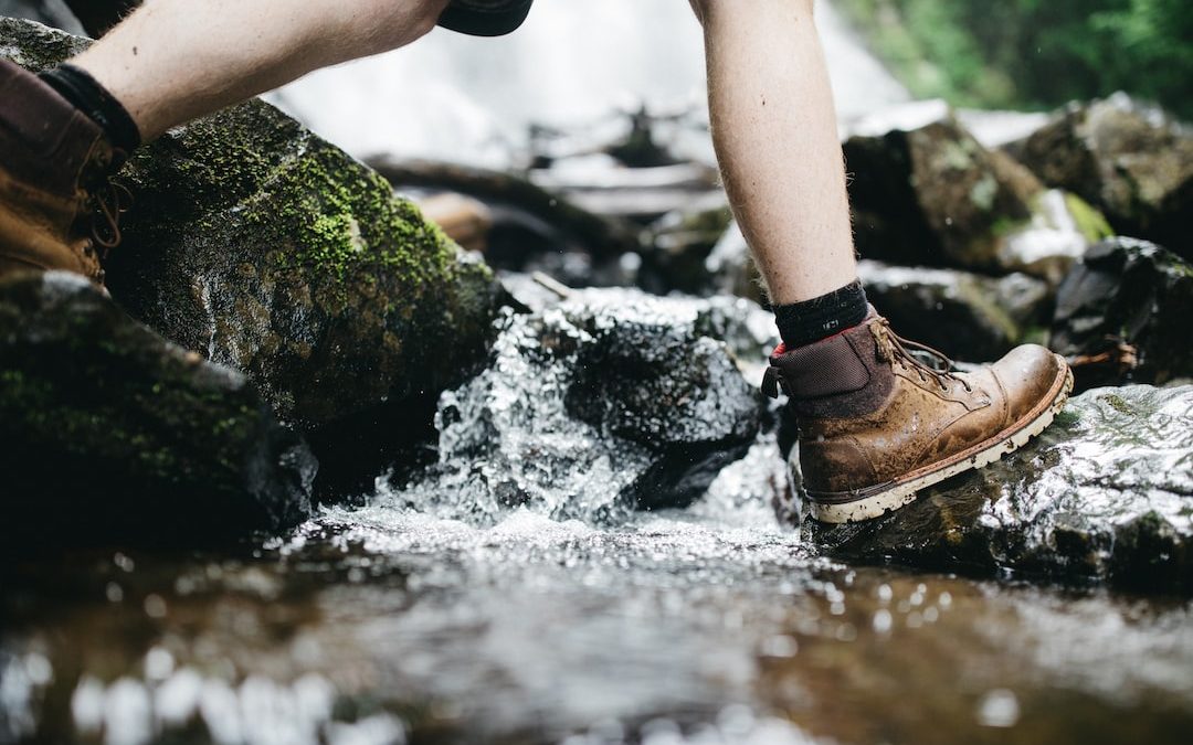 person stepping on rock