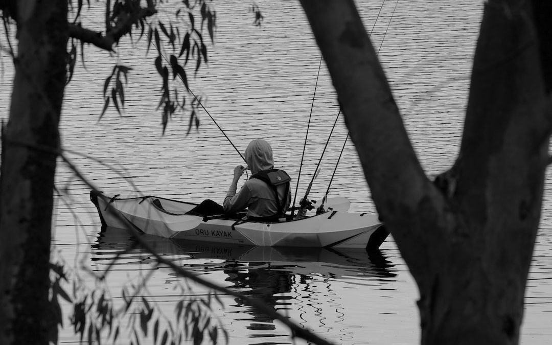 a man in a canoe with a fishing rod