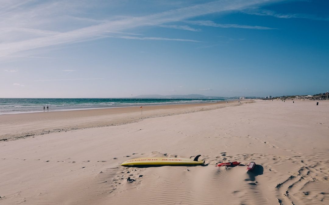 a couple of surfboards on a beach