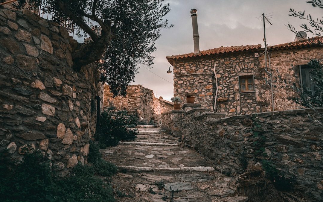 a stone path leading to a stone building