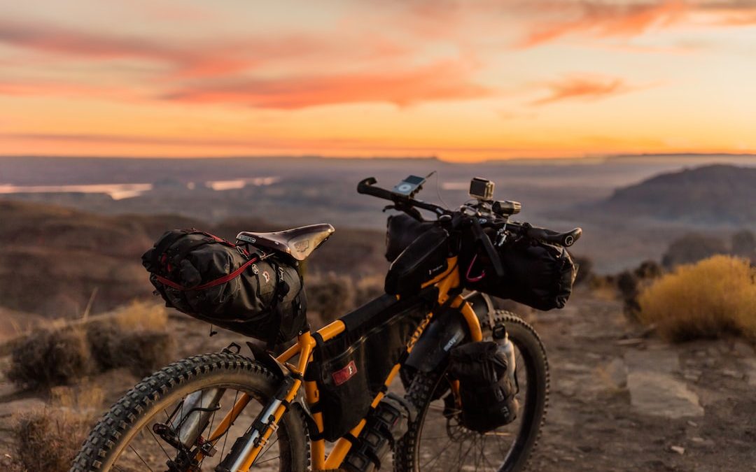 orange and black off-road bicycle on hill