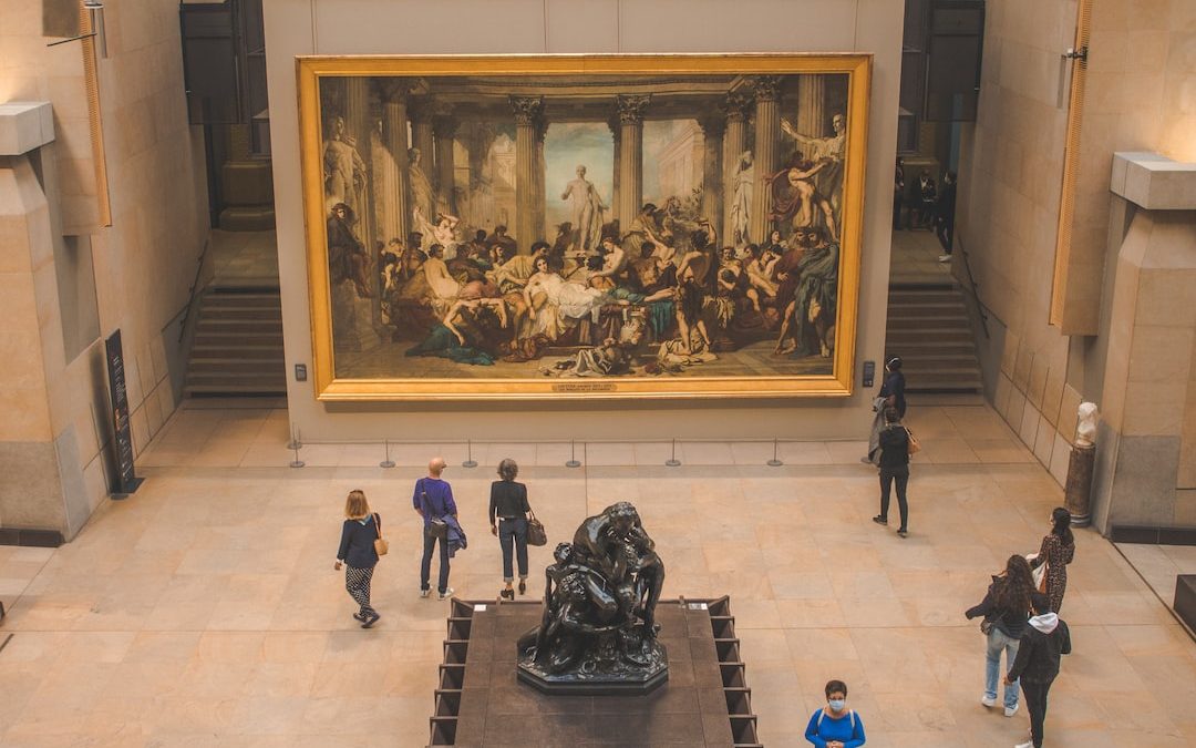 a group of people looking at a painting in a museum